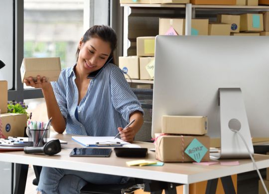 Young Asian woman entrepreneur/ Business owner working with computer at home